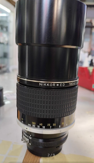  尼康AIS 180/2.8 ED的核心价值不在焦段，而在其ED镜片布局。它采用1组ED镜片（异常色散玻璃），在f/2.8大光圈下有效压制了长焦镜头固有的轴向色差——这是当年为解决彩色胶片高对比度场景下紫边泛滥而设计的。对比今日许多入门级70-200mm镜头，即便标...